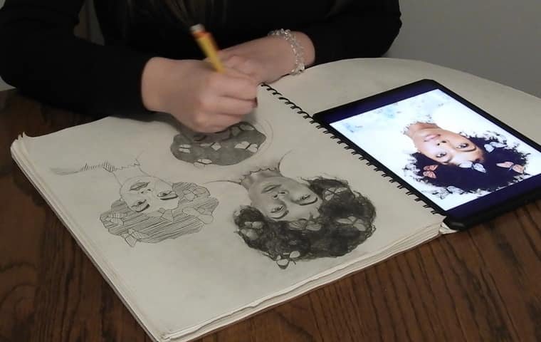 A student sketching three portraits in pencil from a reference on a tablet during a private lesson